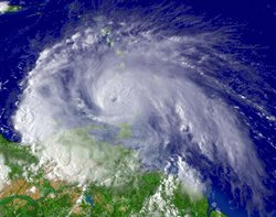 Hurricane Ivan just west of Grenada in the Caribbean Sea on September 7, 2004 at 19:45 UTC (15:45 EDT). At the time, Ivan had maximum sustained winds of 120 mph (195 km/h), placing it at Category 3 on the Saffir-Simpson Hurricane Scale.  Visible satellite image courtesy NOAA.